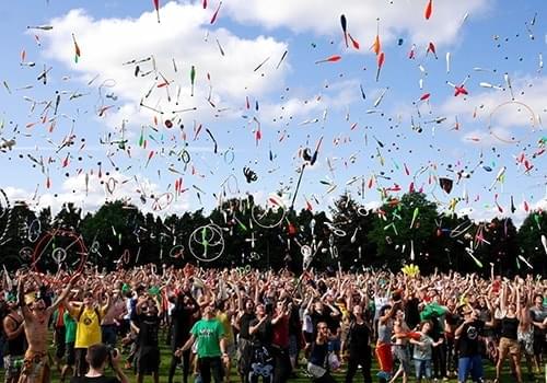 Crowd throwing objects in the air